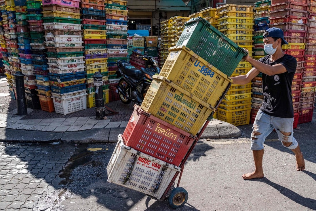 A worker pushes crates at a fruit market in Kuala Lumpur on May 4, 2020. Photo: AFP