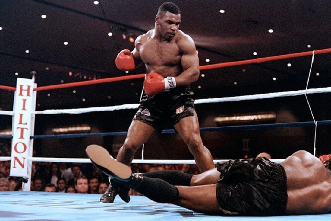 Mike Tyson became the youngest heavyweight champion at 20 years old when he knocked out Trevor Berbick in 1986. Photo: AFP/Getty Images