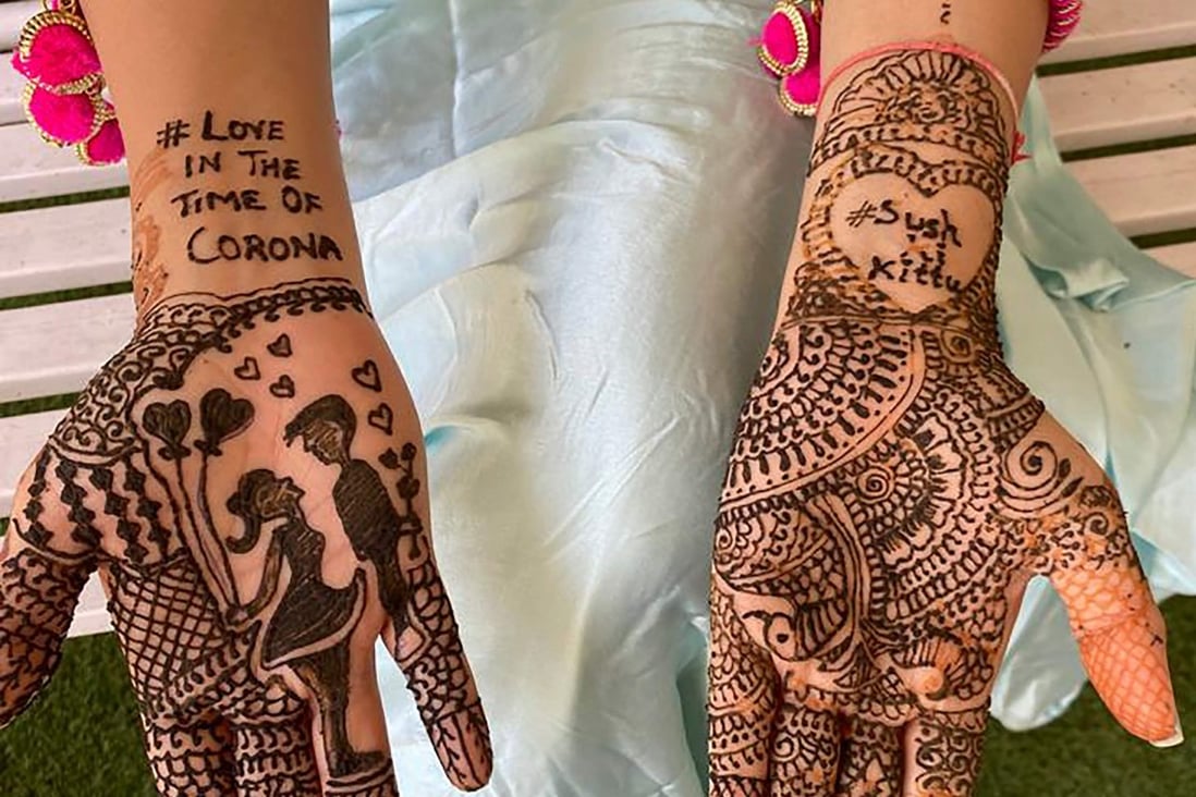 This handout photo taken on April 19, 2020 received courtesy of Shaadi.com shows bride Keerti Narang showing her bridal heena design at her home in Bareilly before her marriage with groom Sushen Dang (not pictured). Photo: AFP / Courtesy of Shaadi.com