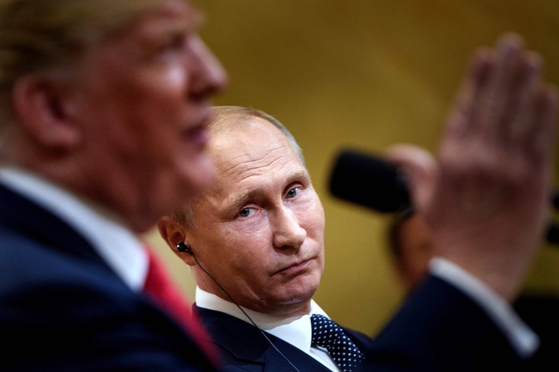 Russia's President Vladimir Putin listens while US President Donald Trump speaks during a press conference in Helsinki, Finland, in July 2018. Photo: AFP