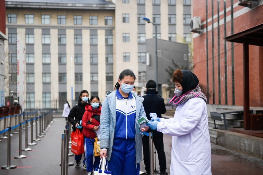 Students wait in line to get their body temperature checked at the No 87 Middle School in Changchun, northeast China's Jilin province, on April 20, 2020. Photo: Xinhua