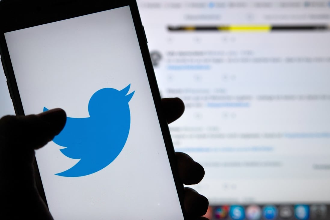 A person holds a phone displaying the logo of the Twitter social media platform. Photo: DPA