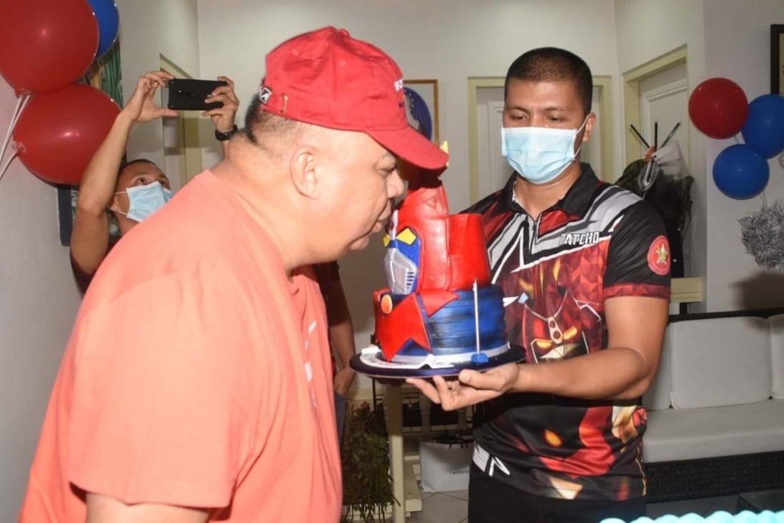 Debold Sinas blows out a candle during his surprise birthday party. Photo: Twitter