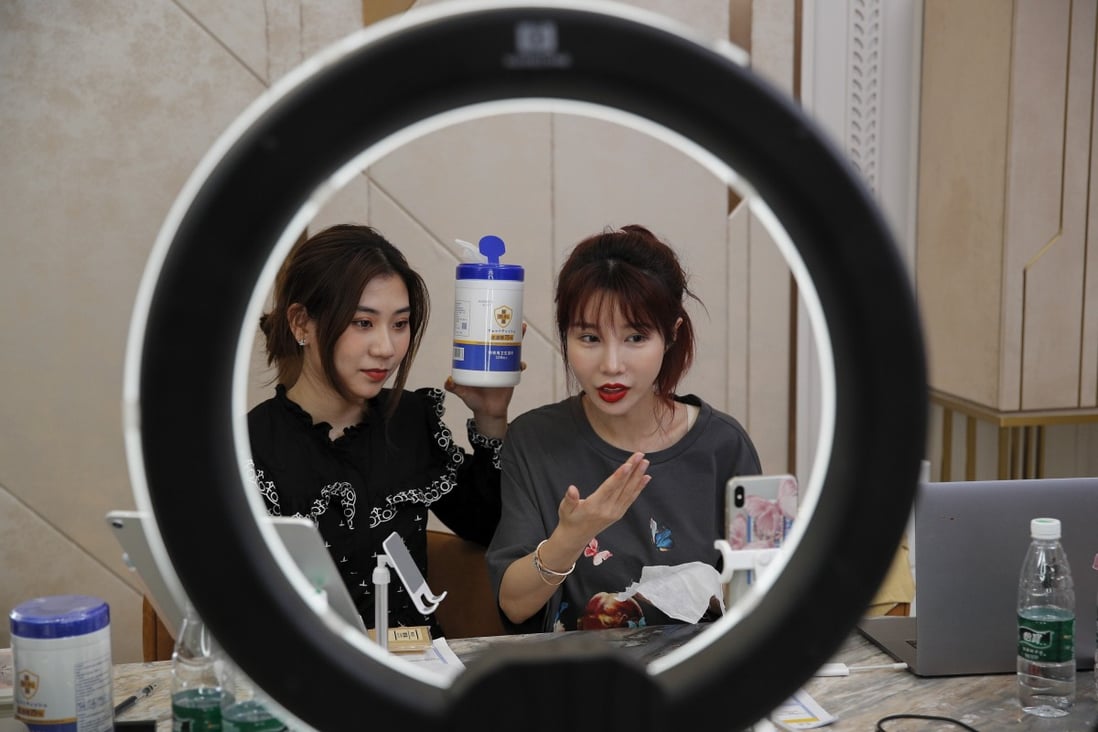 Chinese online celebrity Zhang Mofan (right) introduces disinfectant wipes to her online clients and fans via a live-streaming session from her flat in Beijing on May 5. Photo: AP
