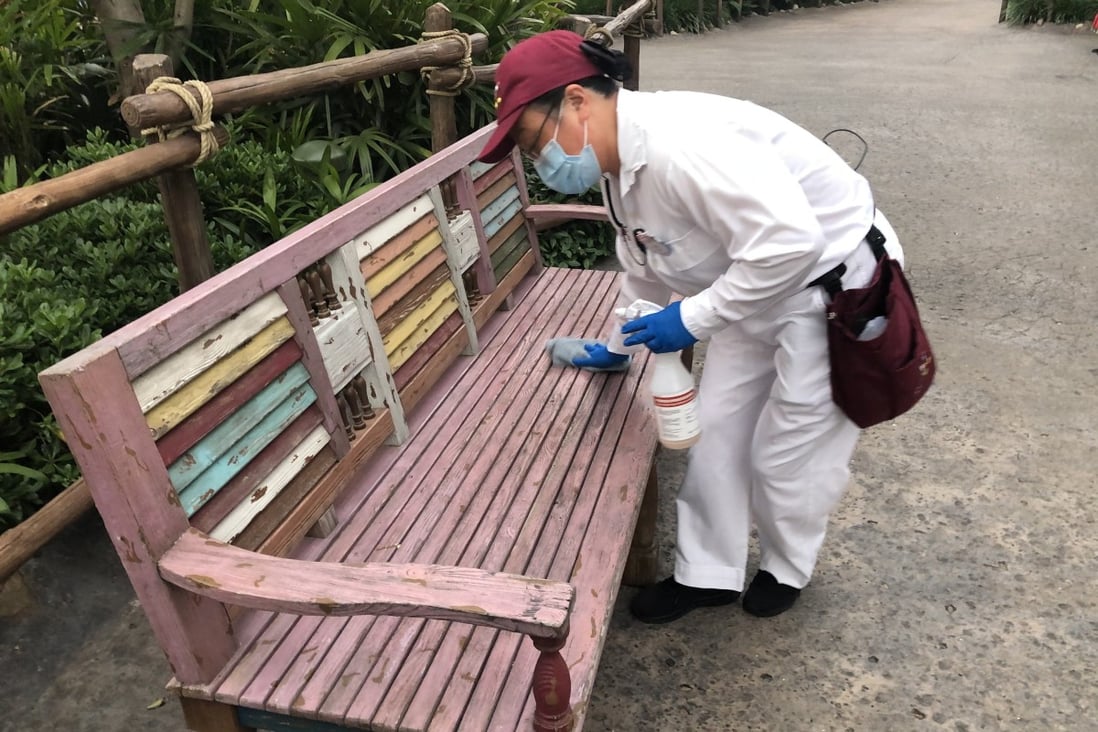 A worker sterilises a bench at Shanghai Disneyland on Monday. Photo: Daniel Ren
