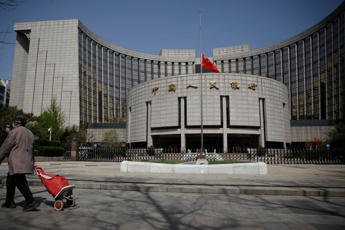 The Chinese flag flies at half-mast at the headquarters of the People's Bank of China on a national day of mourning for Covid-19 victims. Photo: Reuters