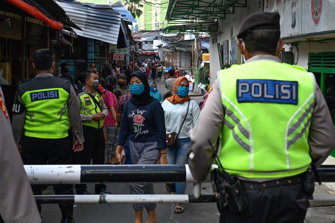 Indonesian police conduct an operation against market vendors defying a partial lockdown as part of efforts to stop the spread of Covid-19. Officials are on alert as the end of Ramadan approaches. Photo: AFP