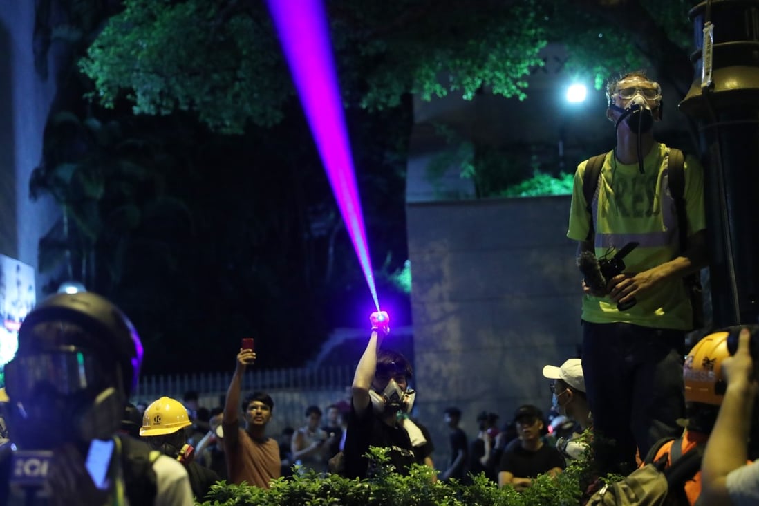 An anti-government protester shines a laser pointer at police in Tsim Sha Tsui in August, 2019. Photo: Sam Tsang