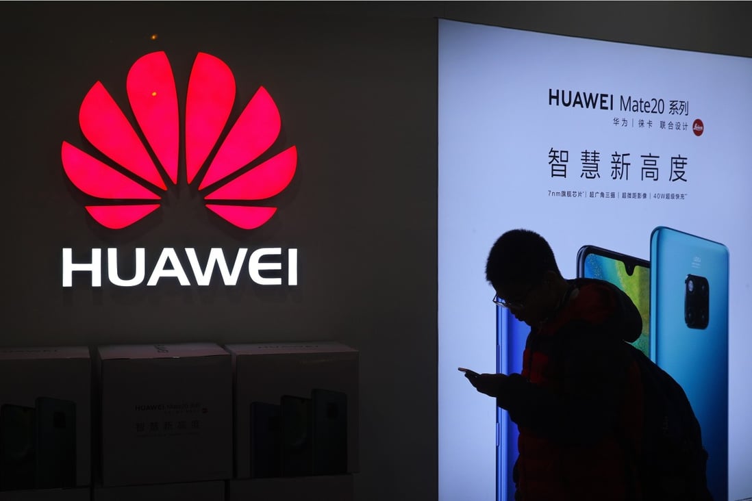 A man looks at his smartphone outside a Huawei store in Beijing in December 2018. Photo: AP