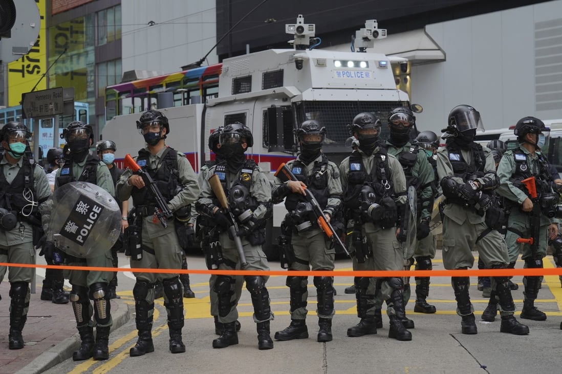 Riot police stand in front of water cannon tuck during a protest against Beijing's national security legislation in Causeway Bay on May 24. Photo: AP