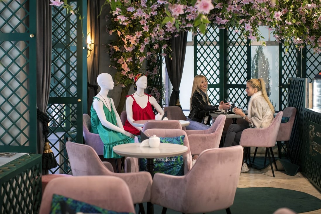 Two friends dine next to mannequins dressed in creations by local designers placed to provide social distancing at a restaurant in Vilnius, Lithuania. Photo: AP