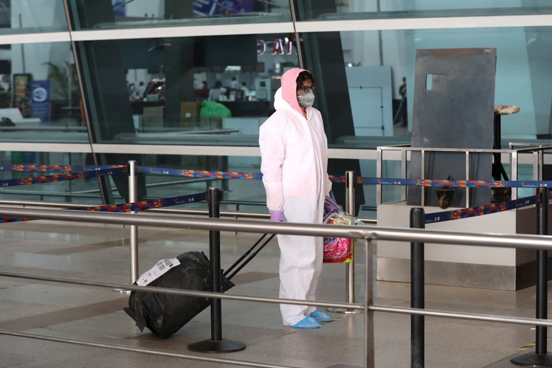 A passenger wearing protective gear arrives at New Delhi’s airport after India resumed domestic flights on Monday. China will repatriate citizens from India on five flights between June 2 and 8. Photo: EPA-EFE