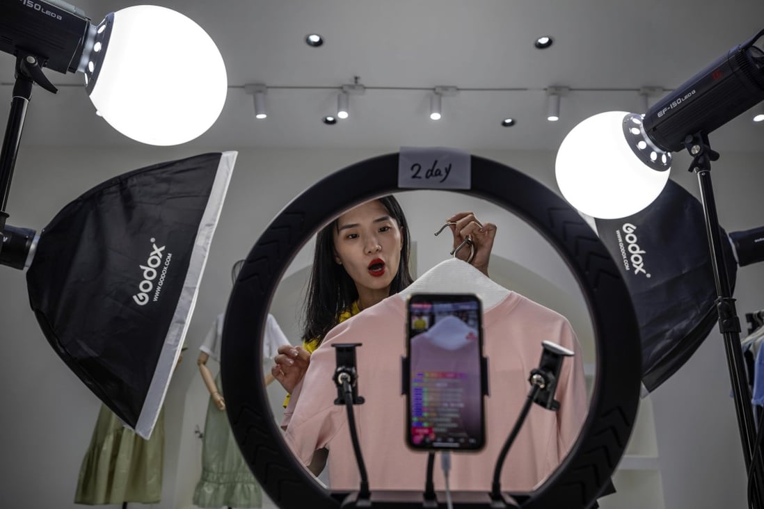 A host presents goods for sale online in the Gonoy Clothing Company studio in Guangzhou, China, May 20, 2020. Tapping into live streaming has become a hot trend in China this year. Photo: EPA-EFE