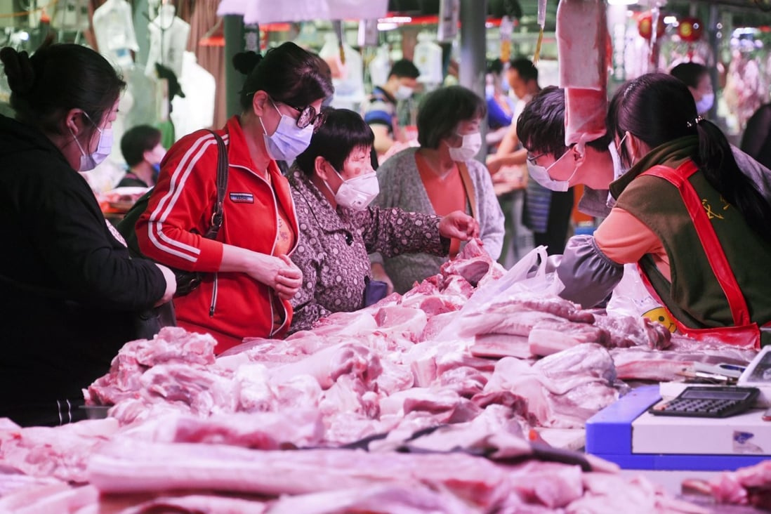 Consumers are seen buying pork at a market in Beijing on May 5. Prices have eased since the Lunar New Year amid rising supply from local and import sources. Photo: Kyodo