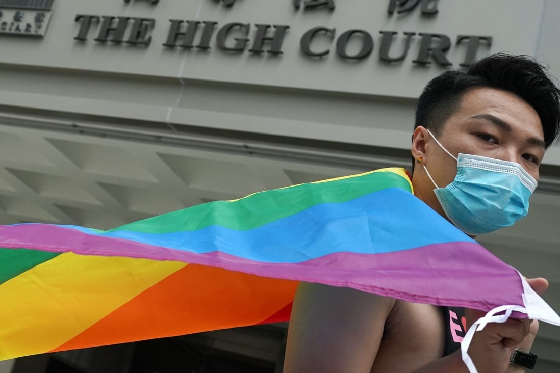 Jimmy Sham with the rainbow flag at the High Court on Friday. Photo: Felix Wong