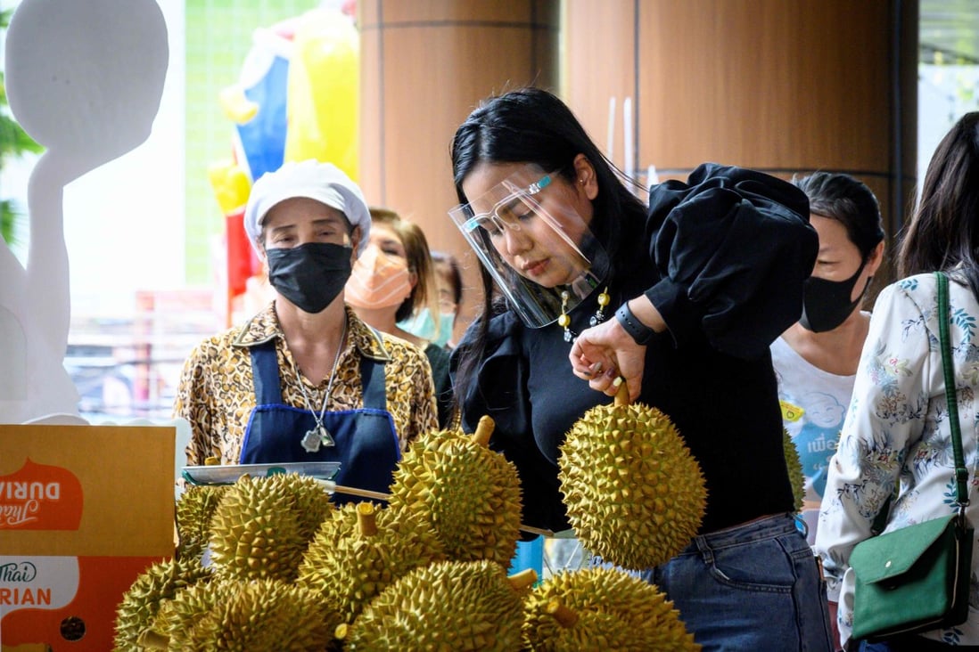 A vendor sells durian at a street stall in Bangkok on May 28. Thai fruit, including durian, have become popular among Chinese consumers, but exports have plunged due to the coronavirus pandemic. Photo: AFP