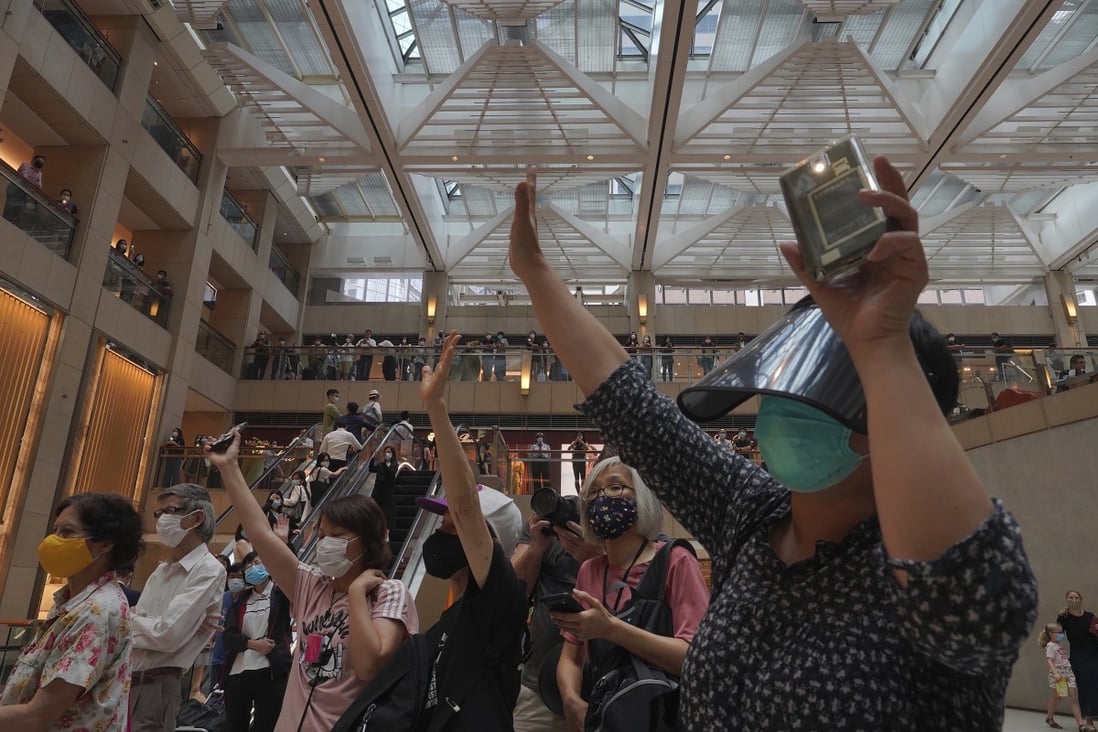 Hong Kong protesters gesture to signify “five demands — not one less”, as they demonstrate at a shopping mall against China’s national security legislation for the city, on June 1. Photo: AP