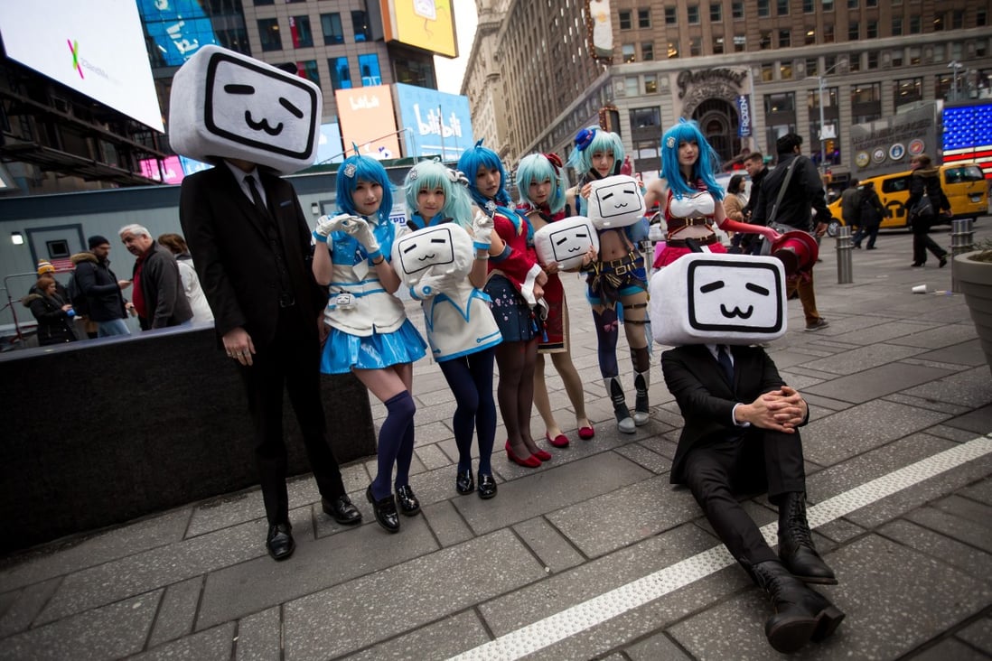 Attendees dressed in anime costumes hold Bilibili logos during the company's initial public offering (IPO) in New York. The Chinese video platform has flagged a warning on the channel of a popular vlogger suspected of spreading disinformation. Photo: Bloomberg