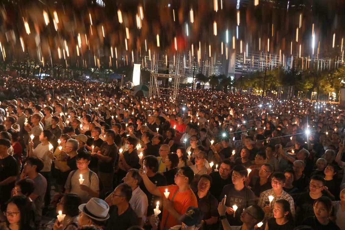 People hold candles aloft during a June 4 candlelight vigil at Victoria Park commemorating the 1989 Tiananmen Square crackdown. Photo: Felix Wong