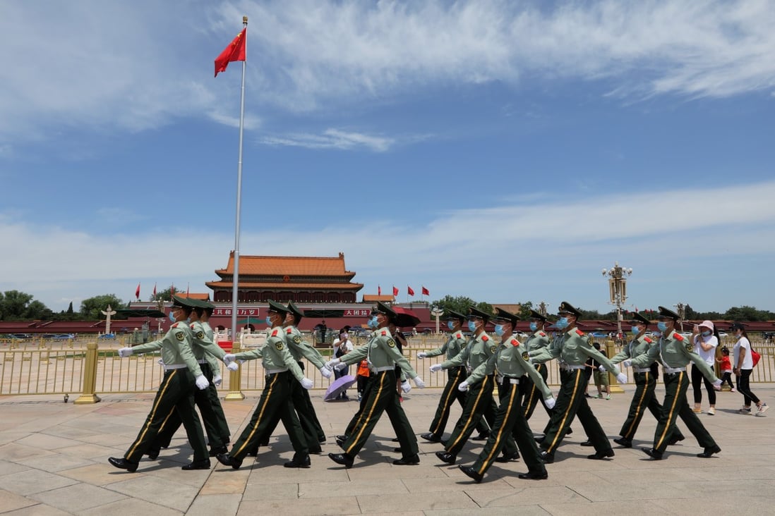 Armed policemen walk through Tiananmen Square in Beijing ahead of the start of this year’s two sessions. Photo: Simon Song