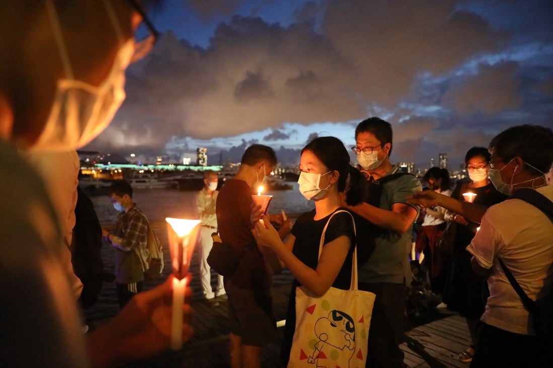People hold up candles at the annual June 4 vigil marking the Tiananmen Square crackdown, in Kwun Tong, Hong Kong. Photo: K. Y. Cheng