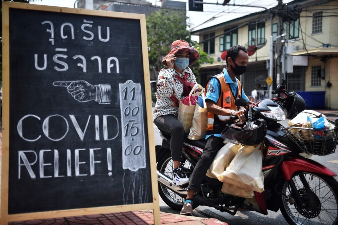 Volunteers transport packages of food and supplies from Covid Relief Bangkok to distribute to the poor. Photo: AFP