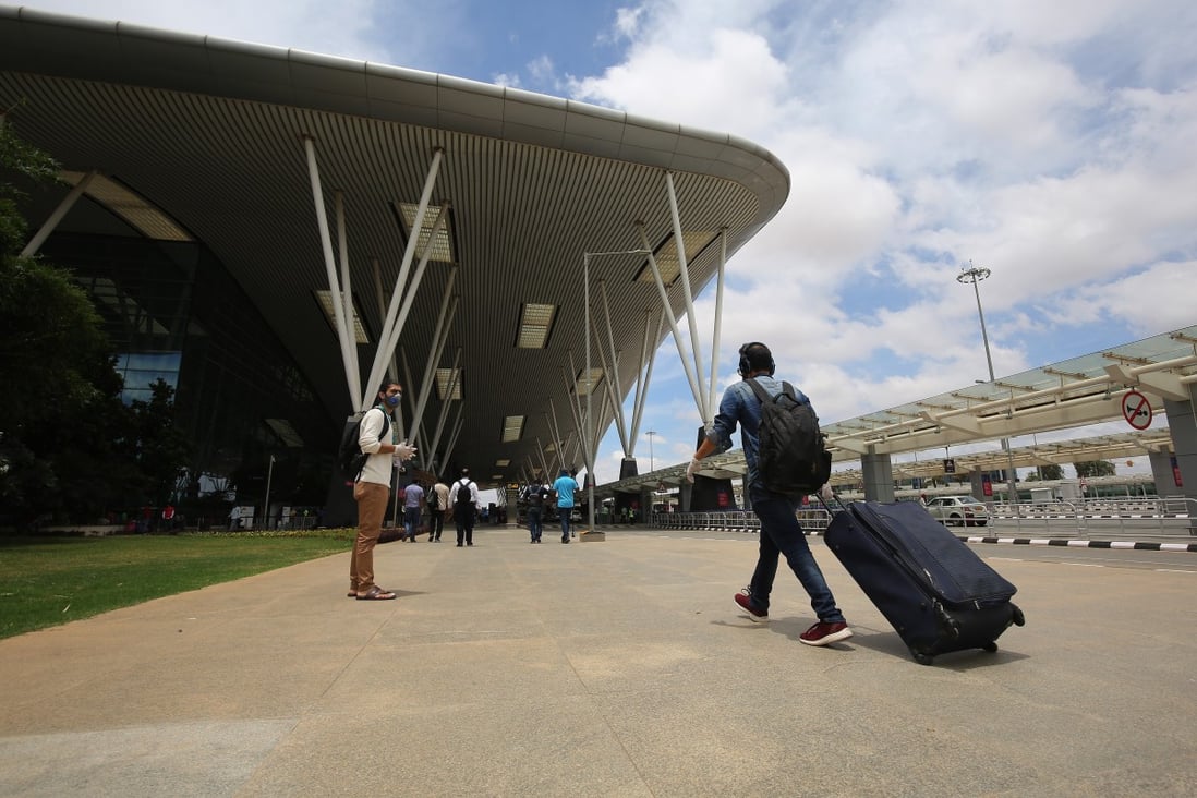 Passengers walk into Kempegowda International Airport in Bangalore after India resumed domestic flights. Chinese citizens stranded in the country will leave on five chartered flights this week. Photo: EPA-EFE
