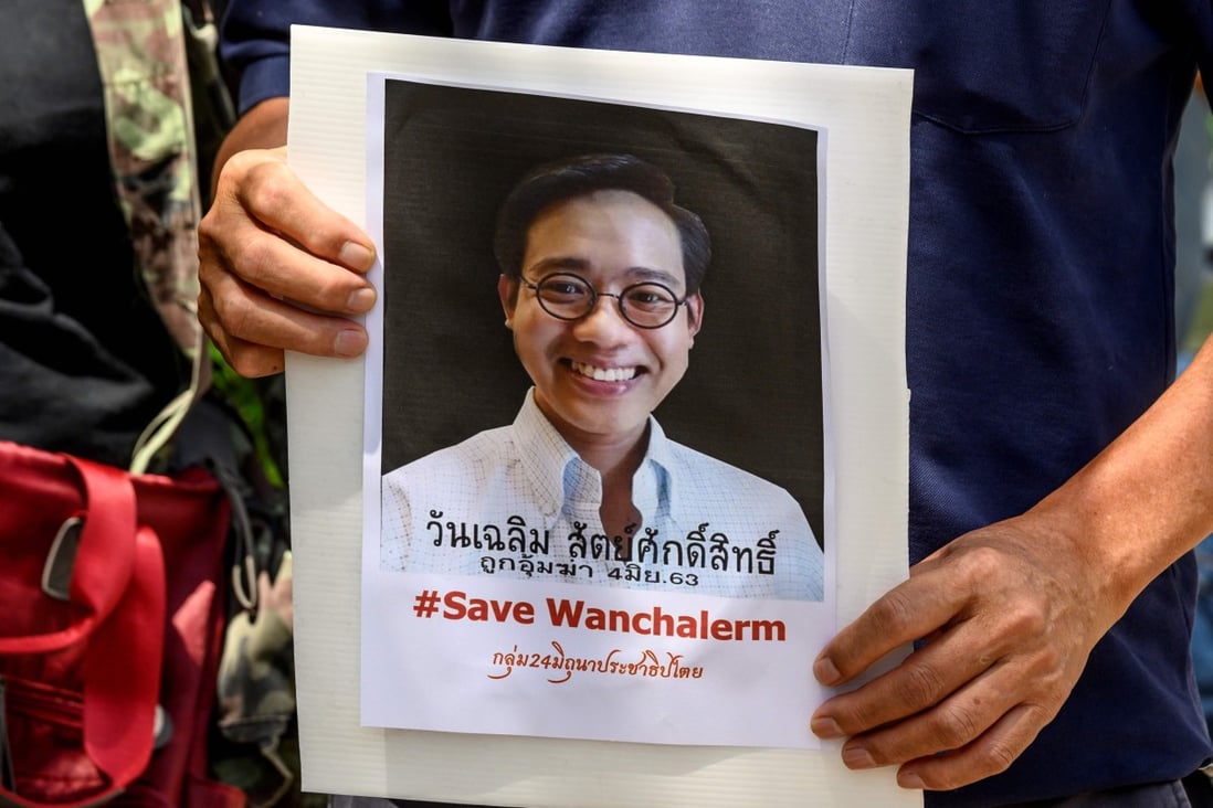 A protester holds a portrait of allegedly kidnapped Thai activist Wanchalearm Satsaksit outside the Embassy of Cambodia in Bangkok. Photo: AFP