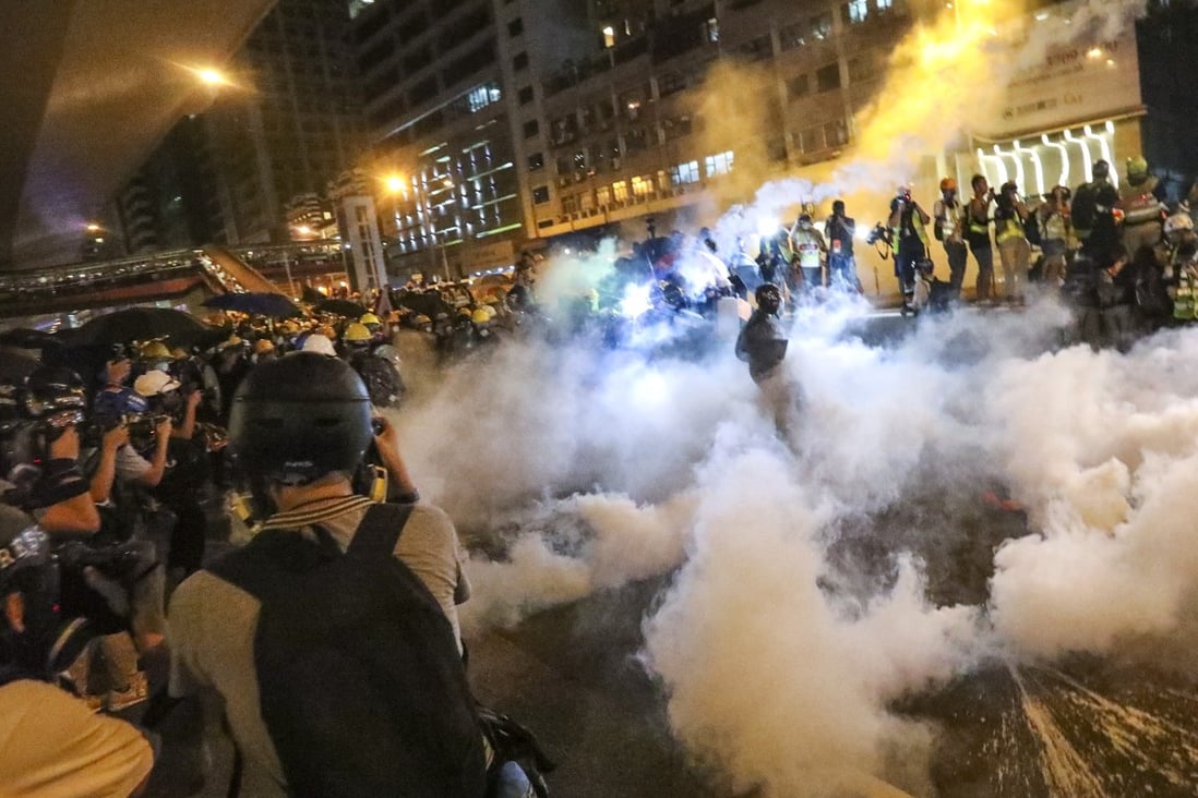 Riot police fire tear gas at protesters as they retreat to Connaught Road in Central during a march against the extradition bill in July last year. Photo: SCMP/Felix Wong