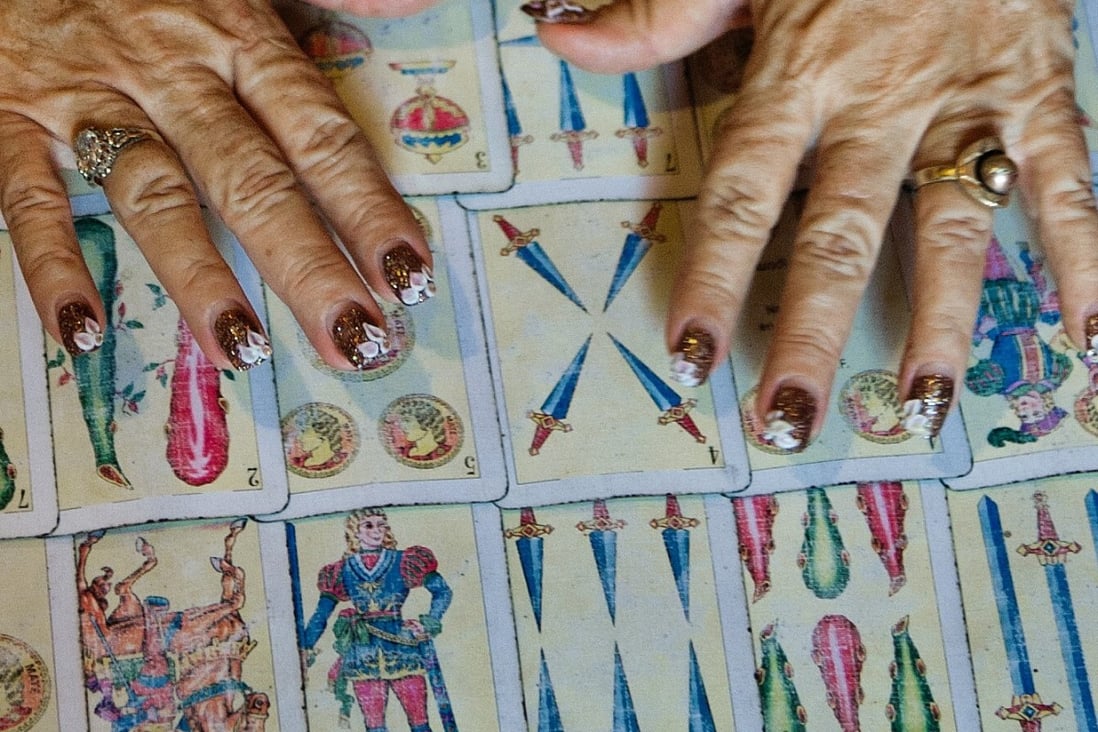 Tarot card readers in Indonesia have been inundated with clients asking if their businesses will survive the coronavirus, will their families be affected and when is the pandemic to end. Photo: AFP via Getty Images