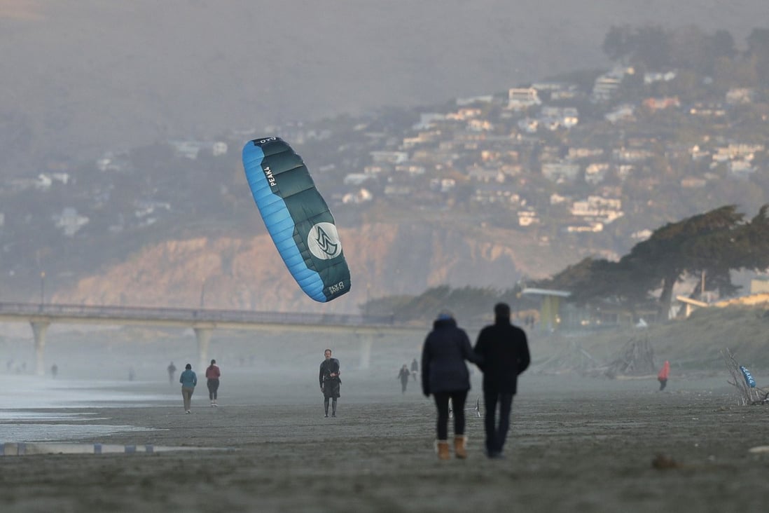 A windsurfer reels in his kite at New Brighton Beach in Christchurch, New Zealand, a day after Prime Minister Jacinda Ardern announced the removal of most coronavirus restrictions. Photo: AP