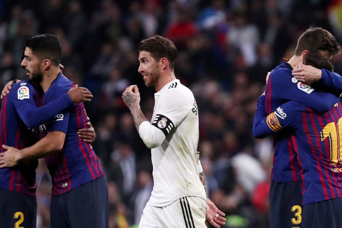 Barcelona's Lionel Messi, Luis Suarez and Gerard Pique celebrate victory as Real Madrid's Sergio Ramos walks off. Photo: Reuters