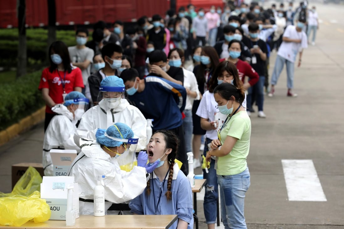 Medical workers take swabs for the coronavirus test at a large factory in Wuhan, where the bulk of Hubei’s cases were reported. Photo: Chinatopix via AP