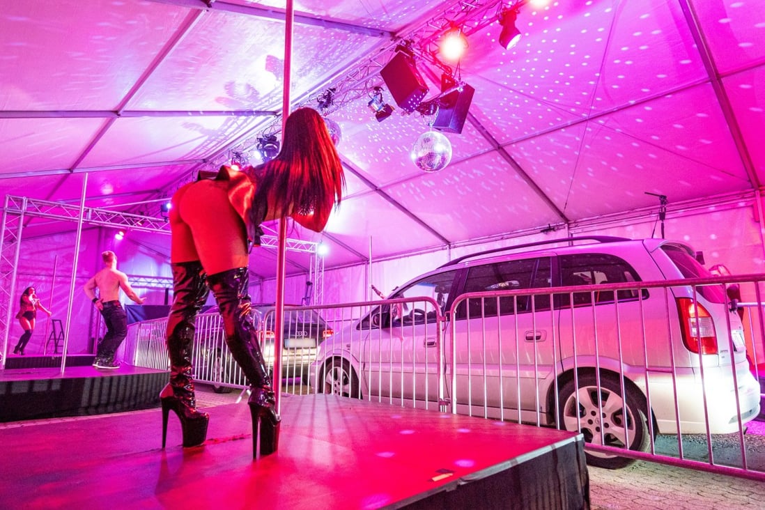 Strippers observing social distancing rules perform for drivers at a drive-through strip show in southern Germany. Photo: DPA