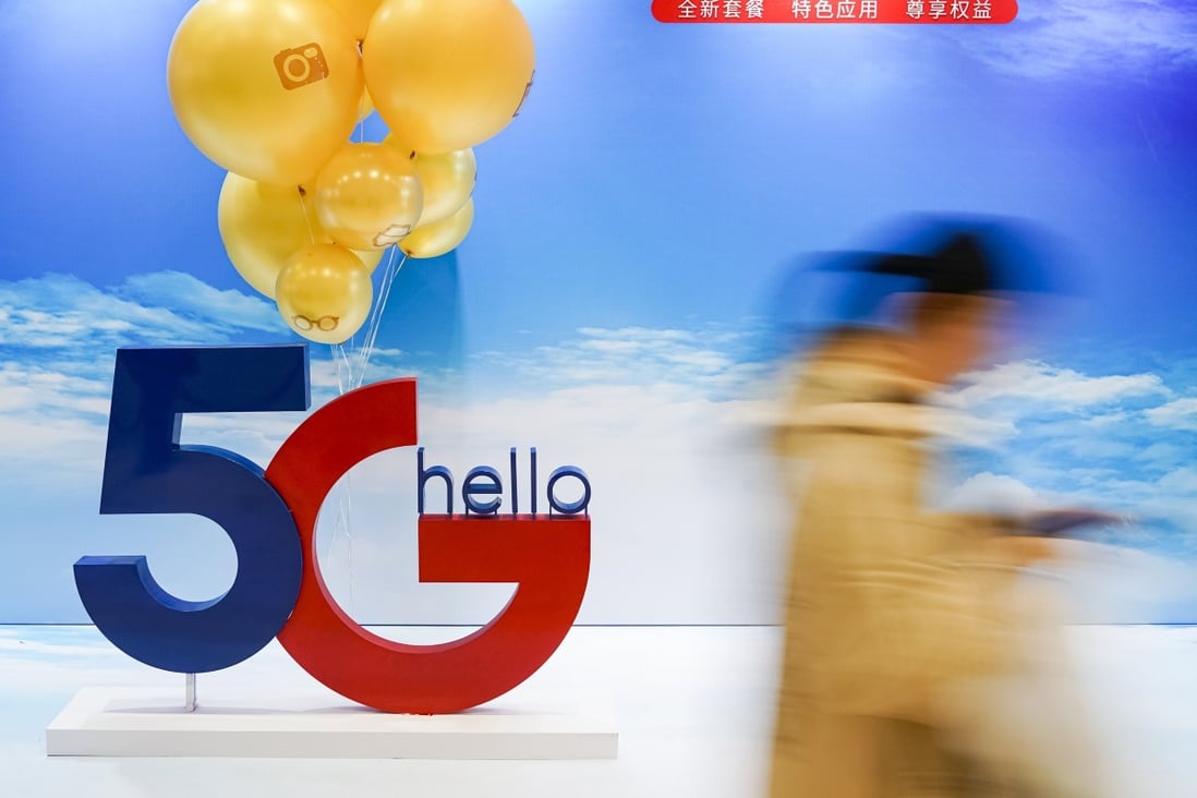 A consumer walks past a poster of commercial 5G applications outside a branch of China Telecom in Beijing in October of last year. Photo: Xinhua