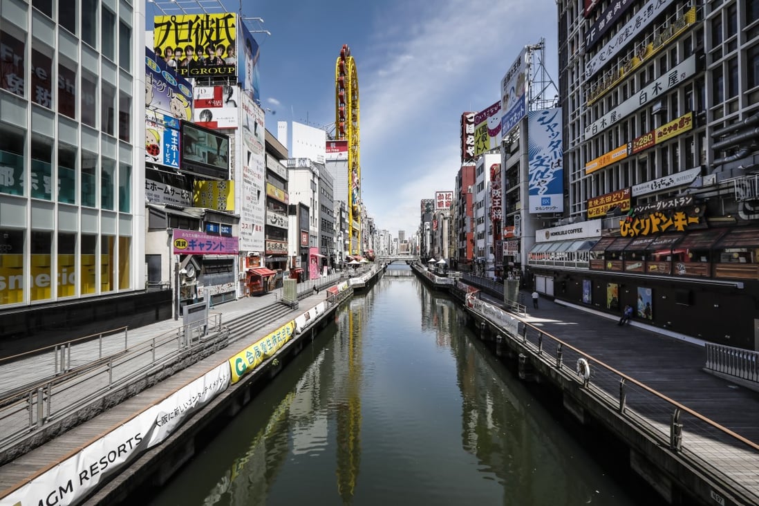 The Dotonbori neighbourhood in Osaka is usually packed with tourists and shoppers. The number of infections in the region has gradually declined and businesses have been slowly reopening but the streets remain quiet. Photo: EPA