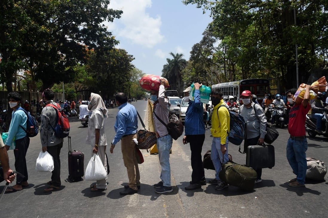 Migrant workers queue outside a Mumbai railway station to return to their hometowns after the government eased a nationwide coronavirus lockdown. Photo: AFP