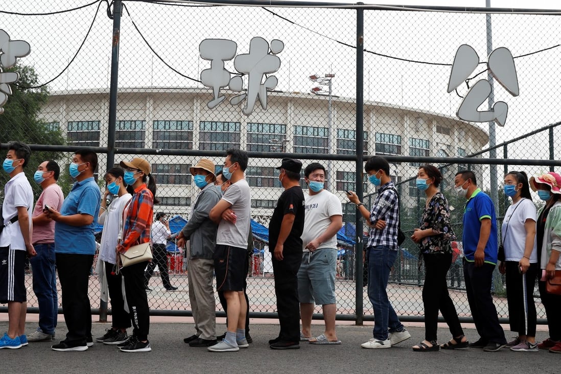 Beijing residents queue outside a sports centre for a Covid-19 nucleic acid test. Photo: Reuters