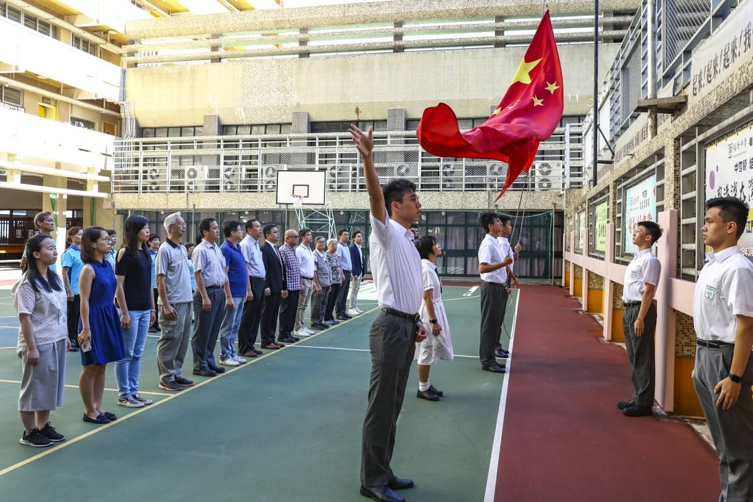 Students, teachers and other staff from Pui Kiu Middle School in North Point take part in the national flag-raising ceremony on campus on August 5, 2019. Photo: Nora Tam