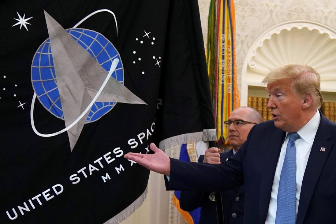 US President Donald Trump views the new Space Force flag in May. The military branch was officially established in December. Photo: Reuters