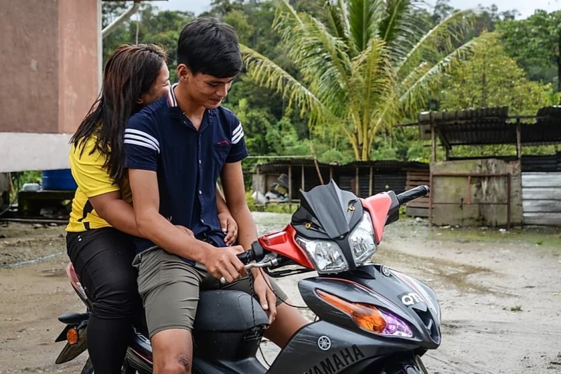 Iris, 16, and Uwix Japan, 19, were married in 2018. Japan says their parents were “very happy” when they wanted to get married. Now, they often go for dates on his motorbike. Photo: Sherlyn Seah