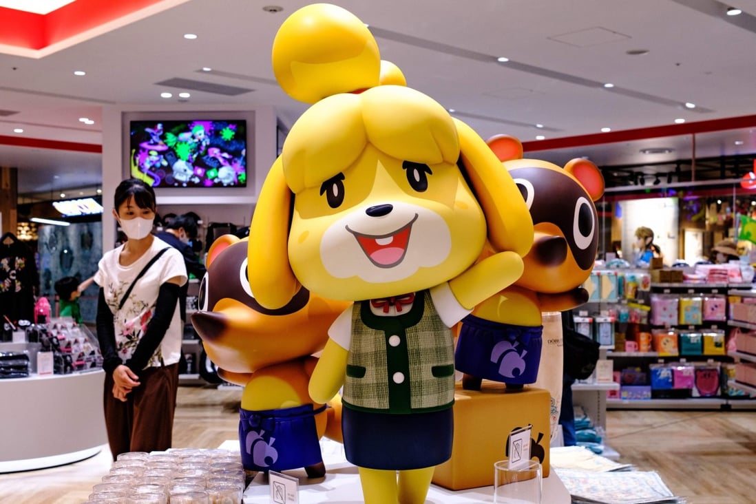 A customer, left, walks past Animal Crossing video game characters at a Nintendo store in Tokyo on June 10. Photo: Agence France-Presse