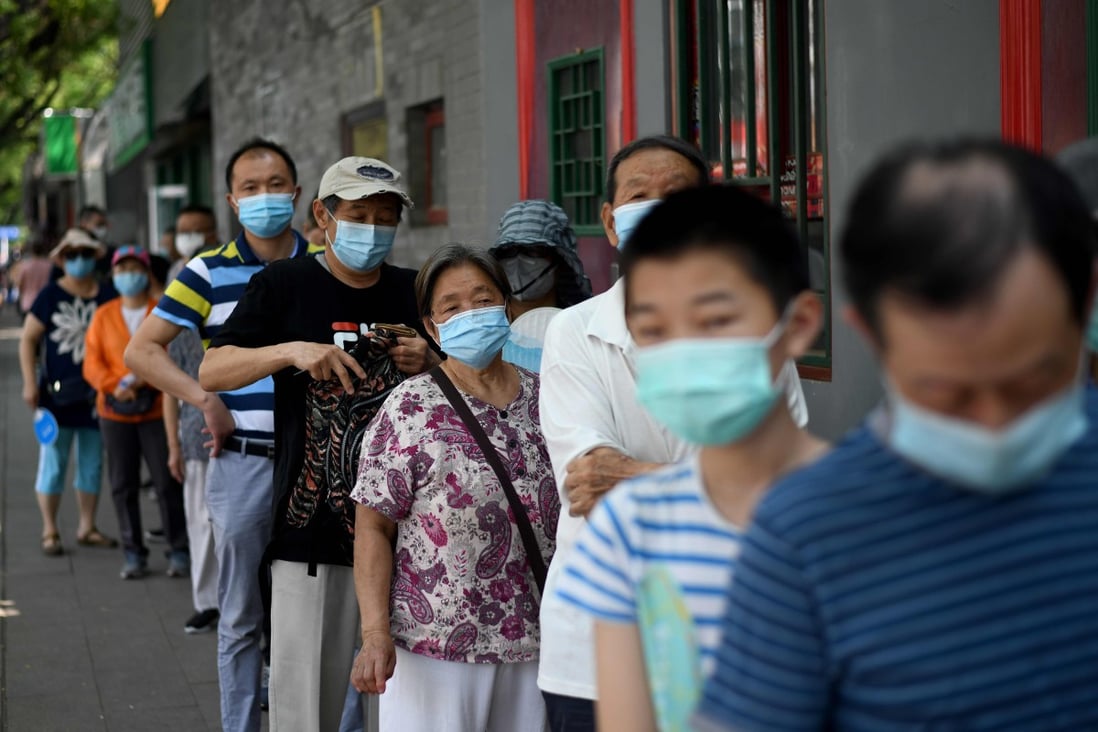 People line up to be tested for the coronavirus in Beijing on Sunday. Photo: AFP
