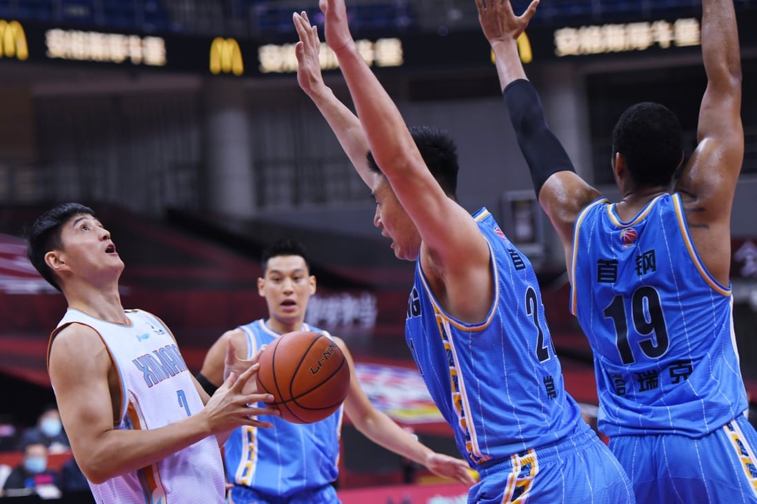 Action from the Chinese Basketball Association game between the Beijing Ducks and Xinjiang Flying Tigers. Photo: Xinhua