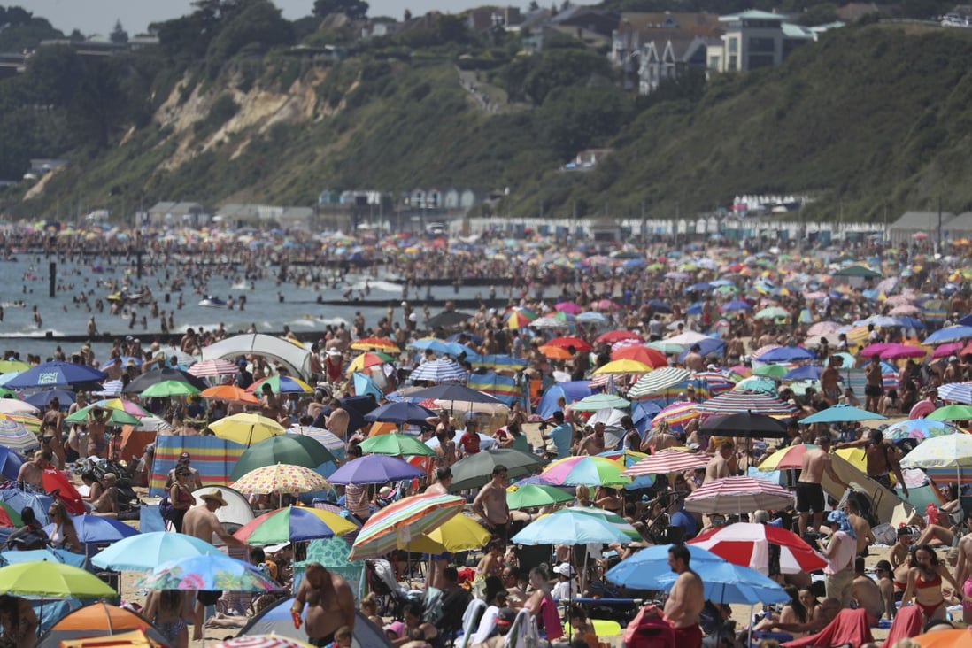 Crowds gather on the beach in Bournemouth, England on Thursday. Photo: PA via AP