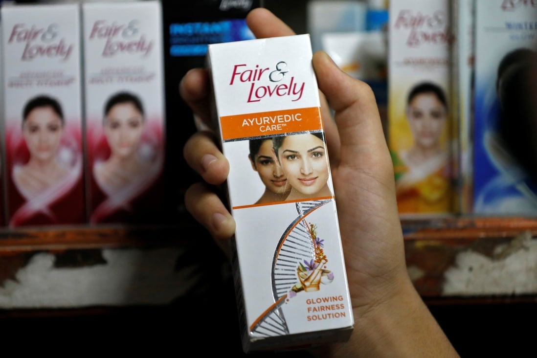 A customer picks up a “Fair & Lovely” skin-lightening cream from a shelf in a shop in Ahmedabad, India. Photo: Reuters