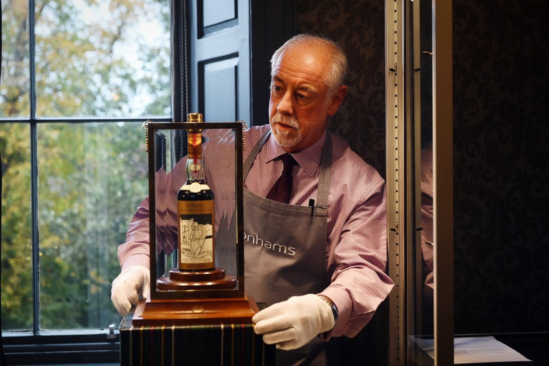 Rare whisky is among luxury assets that attract some wealthy investors. Here, a Bonhams porter shows the bottle of Macallan Valerio Adamai 1926 whisky, which sold for £700,000 (about US$868,500) at auction in Edinburgh on October 3, 2018. A £148,000 sales premium was added on top of its price. Photo: AFP