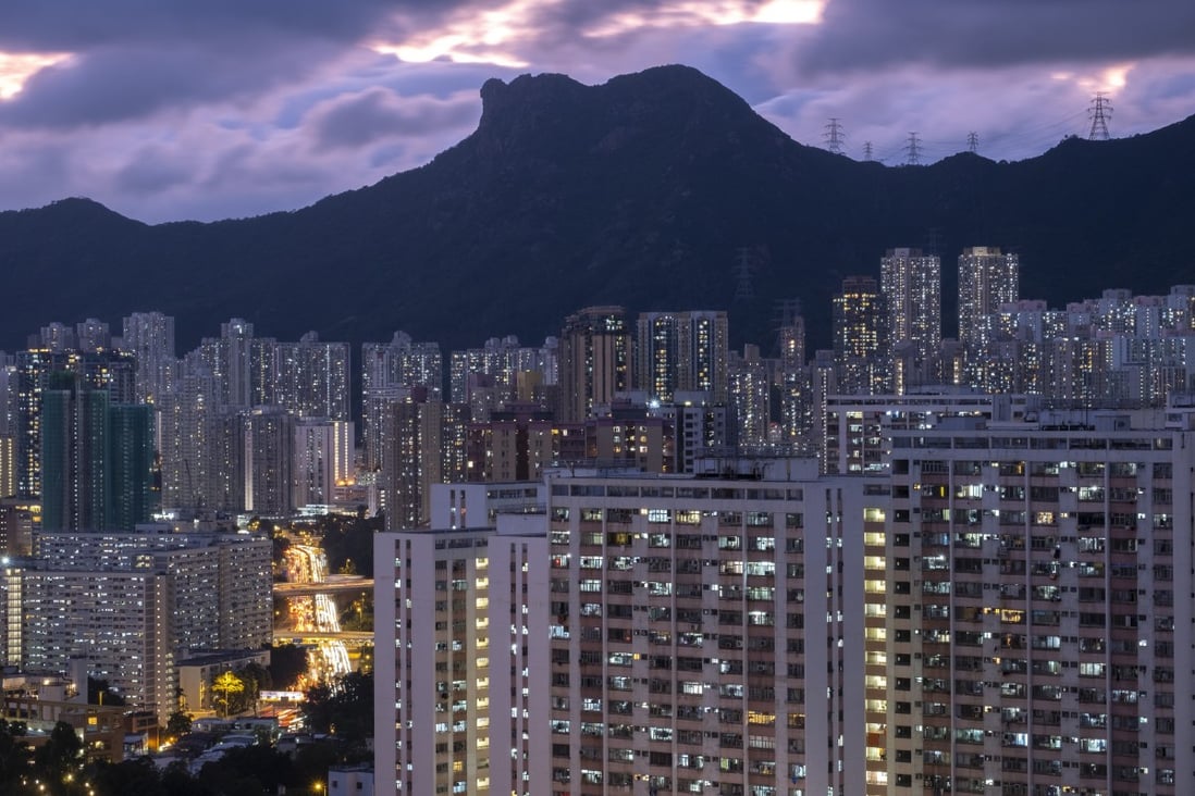 Residential buildings are illuminated under Lion Rock in Kowloon, Hong Kong, on May 7. Lawmakers have shelved plans to impose a vacancy tax, which was designed to punish property developers who hoard newly completed flats, taking advantage of the housing shortages to push up prices. Photo: Sun Yeung