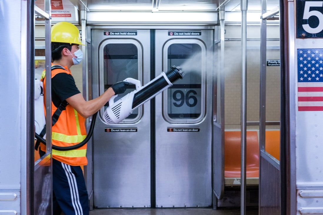 A contractor for the Metropolitan Transit Authority disinfects a subway train using an electrostatic sprayer in New York on June 10. Photo: Bloomberg