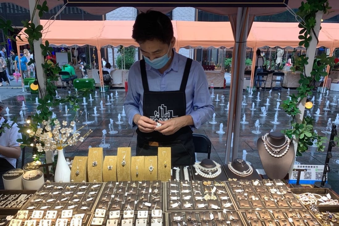 Angus Gu, owner of Goos Jewellery, displays his wares at the BFC Weekend Market. Photo: Daniel Ren